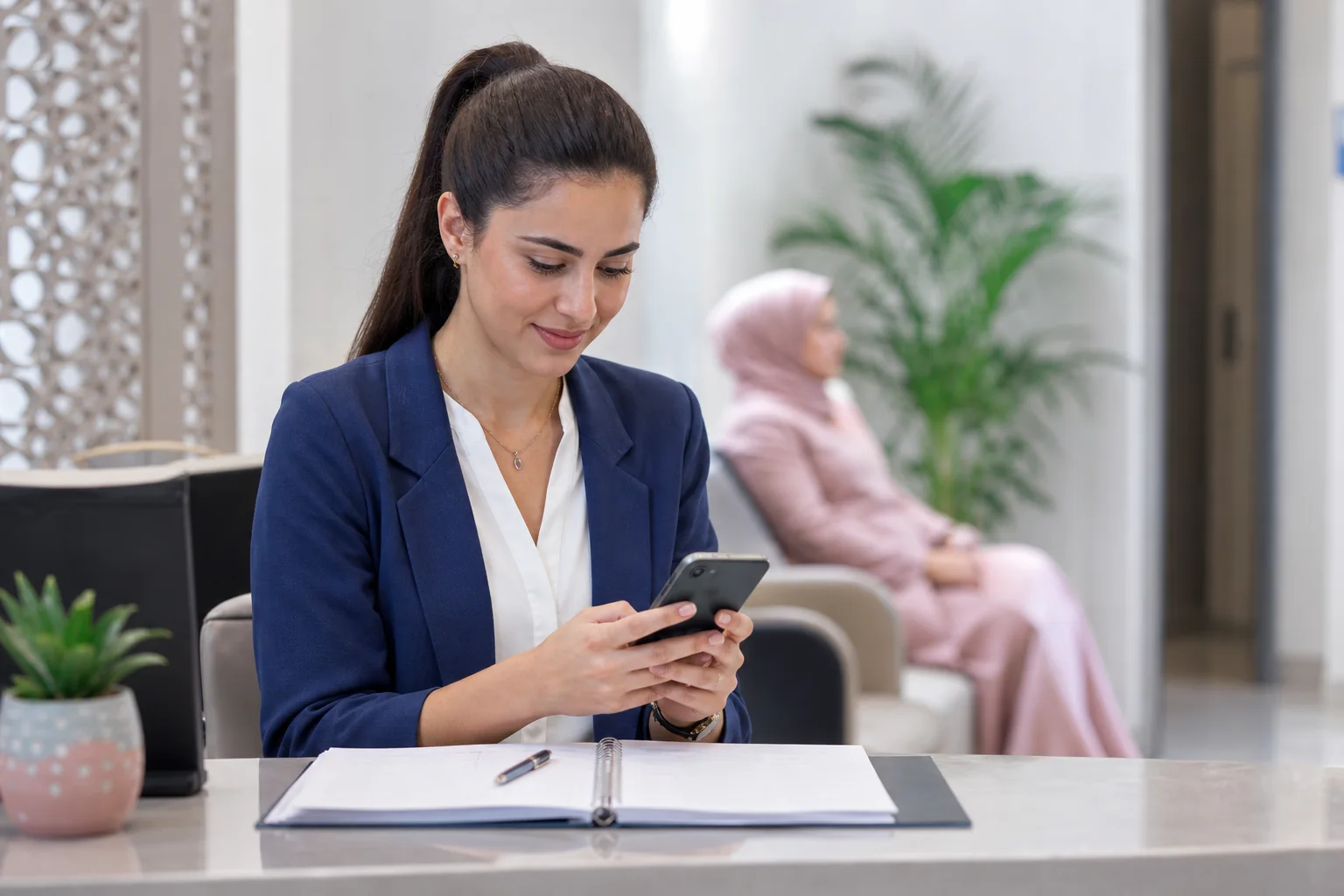Clinic receptionist preparing an appointment reminder