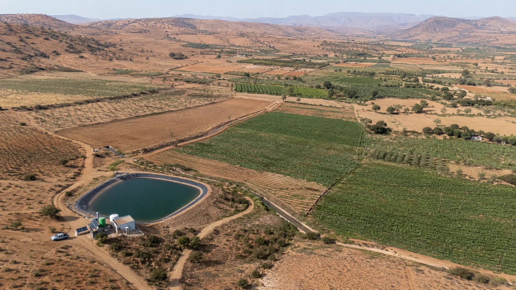 Aerial view of irrigated farmland and water reservoir